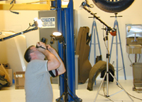 Bentley Service Publications Team photographing undercarriage of a BMW.