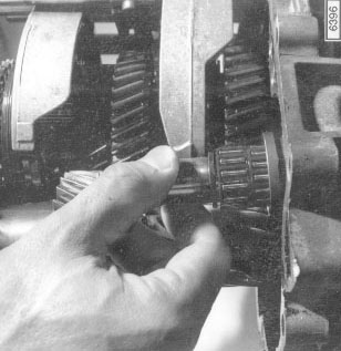Fig. 7-7. Reverse gear shaft being withdrawn from transmission case.

Manual Transmission and Clutch
page 23