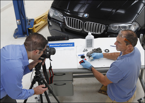 Bentley technical editors repairing xDrive transfer case servomotor.