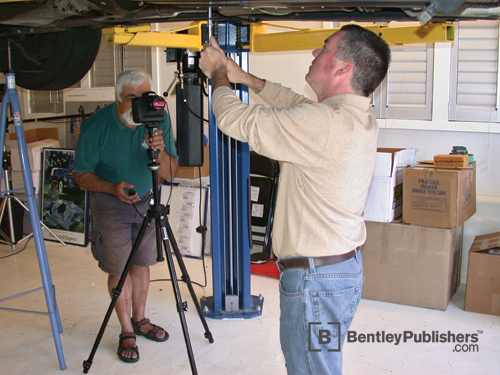 Bentley technical editors photographing fuel filter replacement.