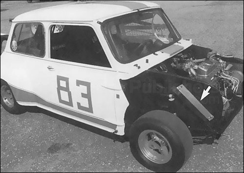 This Mini is a former SCCA racer, modified with fully-removable clip-on hood and fender flares. Note location of oil cooler in wheel well.