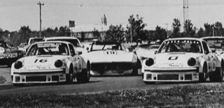 In American racing the Group 4 Porsche 934s continued to be as useful in several series as they had been in 1976 when this SCCA Trans-Am race start took place. George Follmer was in number 16 and Hurley Haywood in number 0.