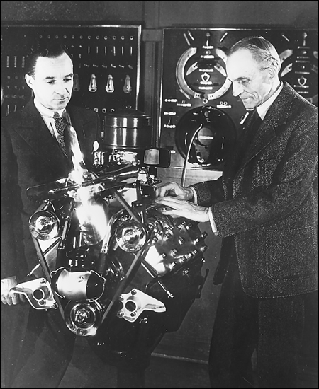 Seen during their prime in the 1930s examining a Ford V-8 engine, Henry Ford, right, and his son Edsel each responded in his own way to the callenge of the Volkswagen and the need to design more advanced automobiles.