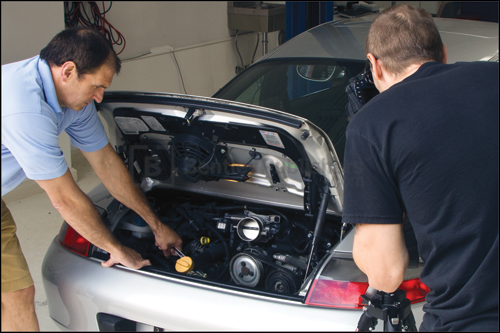Bentley technical editors removing drive belt prior to servicing a 3.6 liter Carrera coupe.