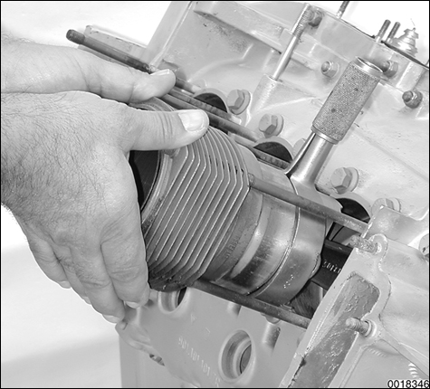 Detailed illustrations for each repair procedure, including use of special tools. Cylinder installation procedure shown using piston ring compressor.
Engine Disassembly and Assembly
page 102-28